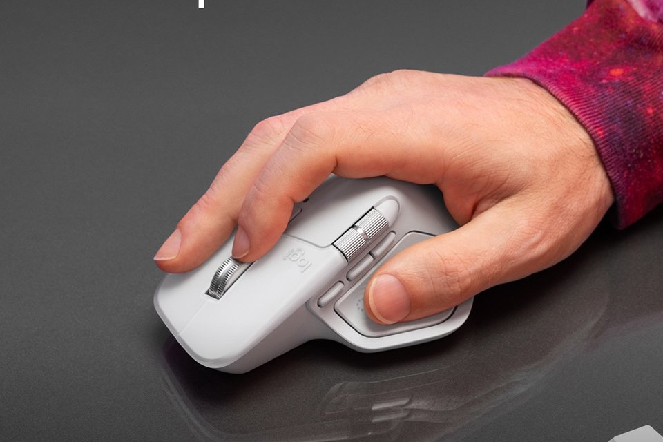A person using a Logitech MX Master 4 Wireless Mouse for Mac.